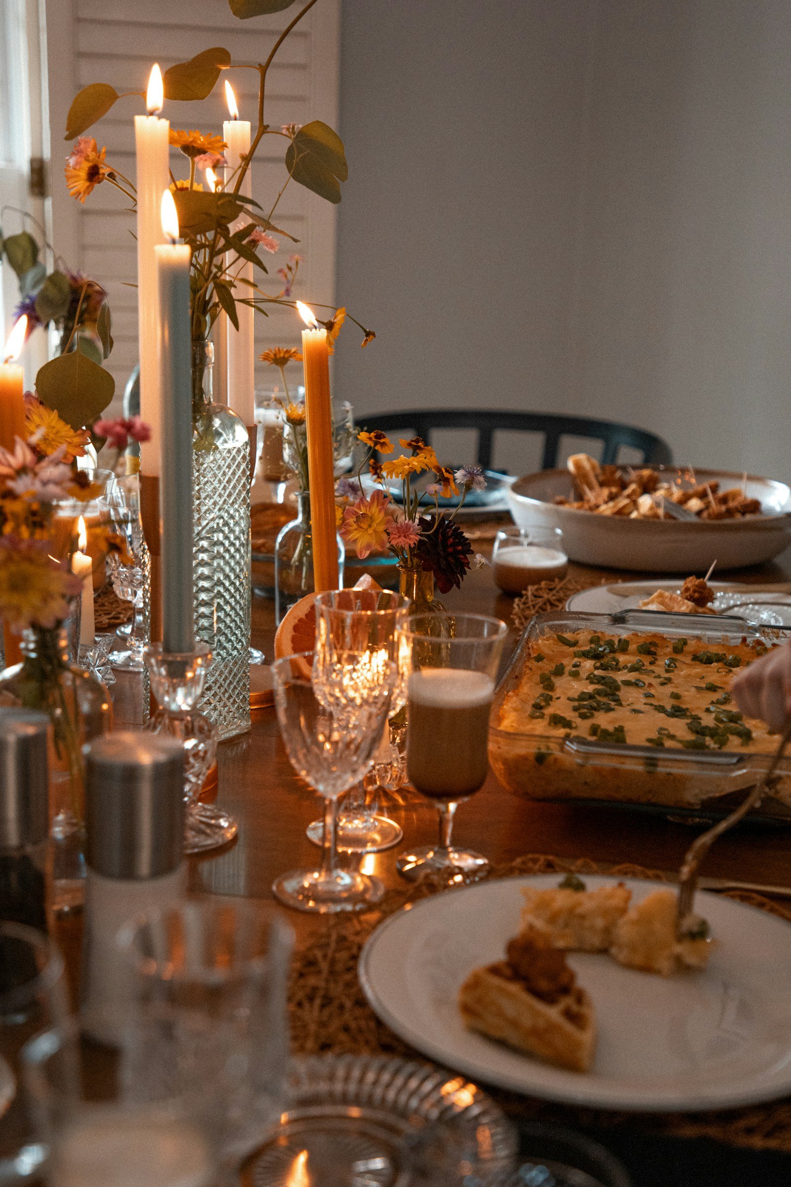 The end of a candlelit dinner, glasses still full